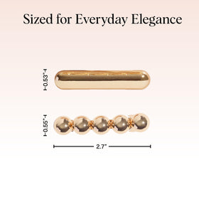 Kitsch gold barrettes resting on textured fabric highlighting lightweight design