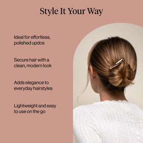 Kitsch gold hair pin on textured surface, emphasizing refined metal look and versatility