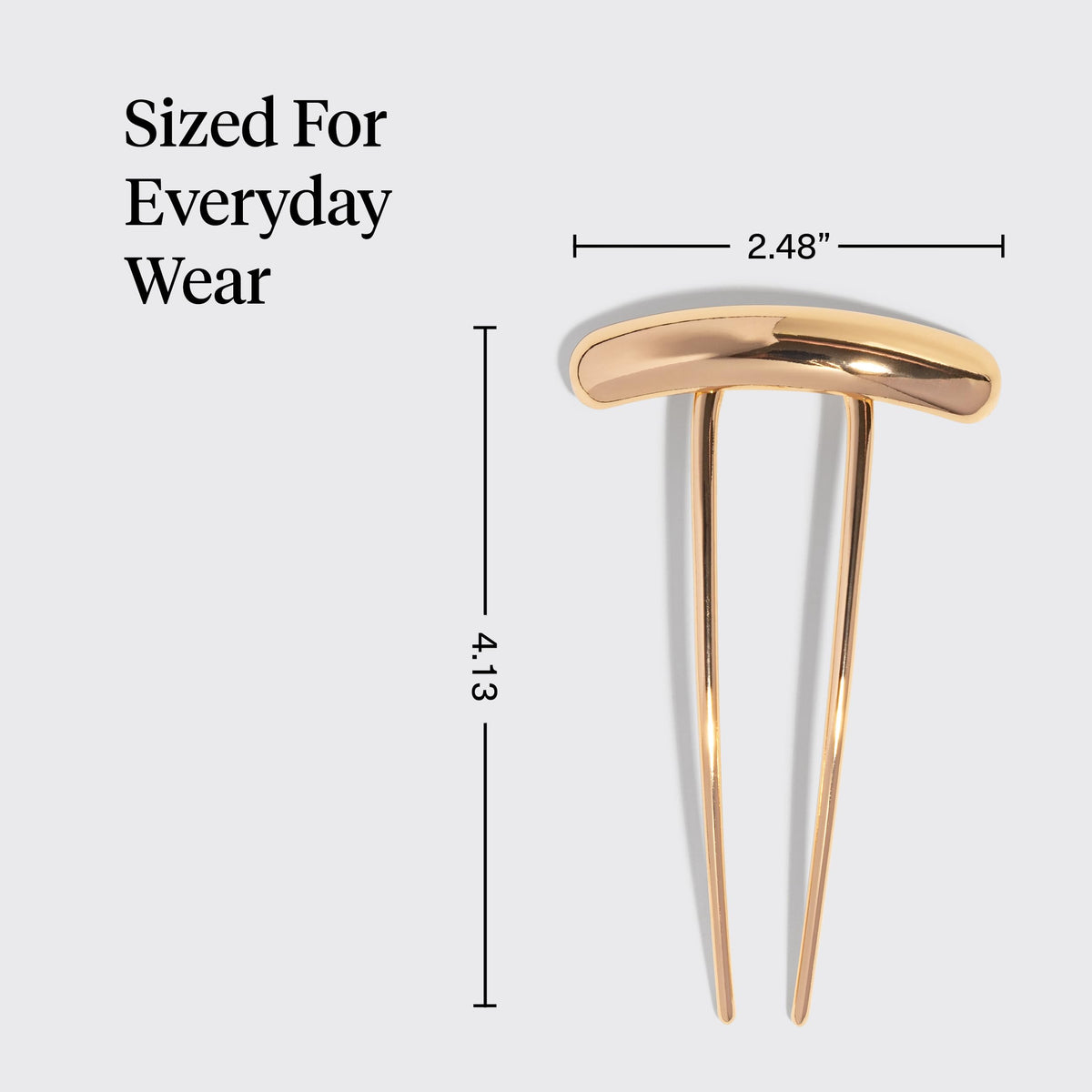 Kitsch gold hair pin next to a ruler for scale to illustrate compact, lightweight size
