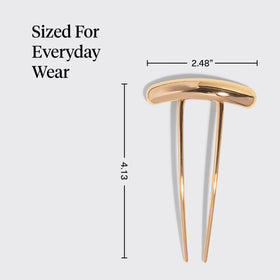 Kitsch gold hair pin next to a ruler for scale to illustrate compact, lightweight size