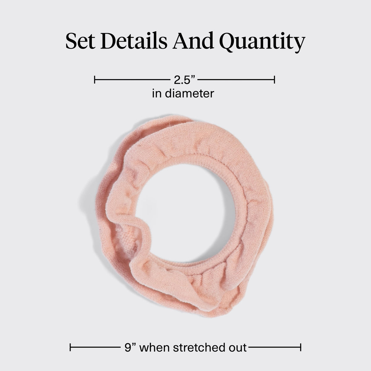 Kitsch hair tie beside a coin to show compact size and easy portability