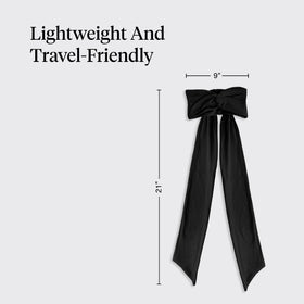 Kitsch headband in hand to show compact travel-friendly size