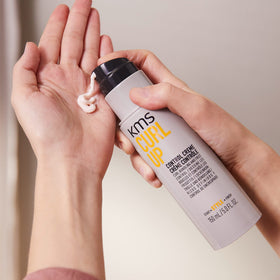 KMS lifestyle shot with model emphasizing natural curls and flexible, glossy hold