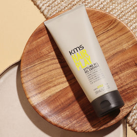 KMS 200ml size comparison next to hand to show compact travel-friendly volume