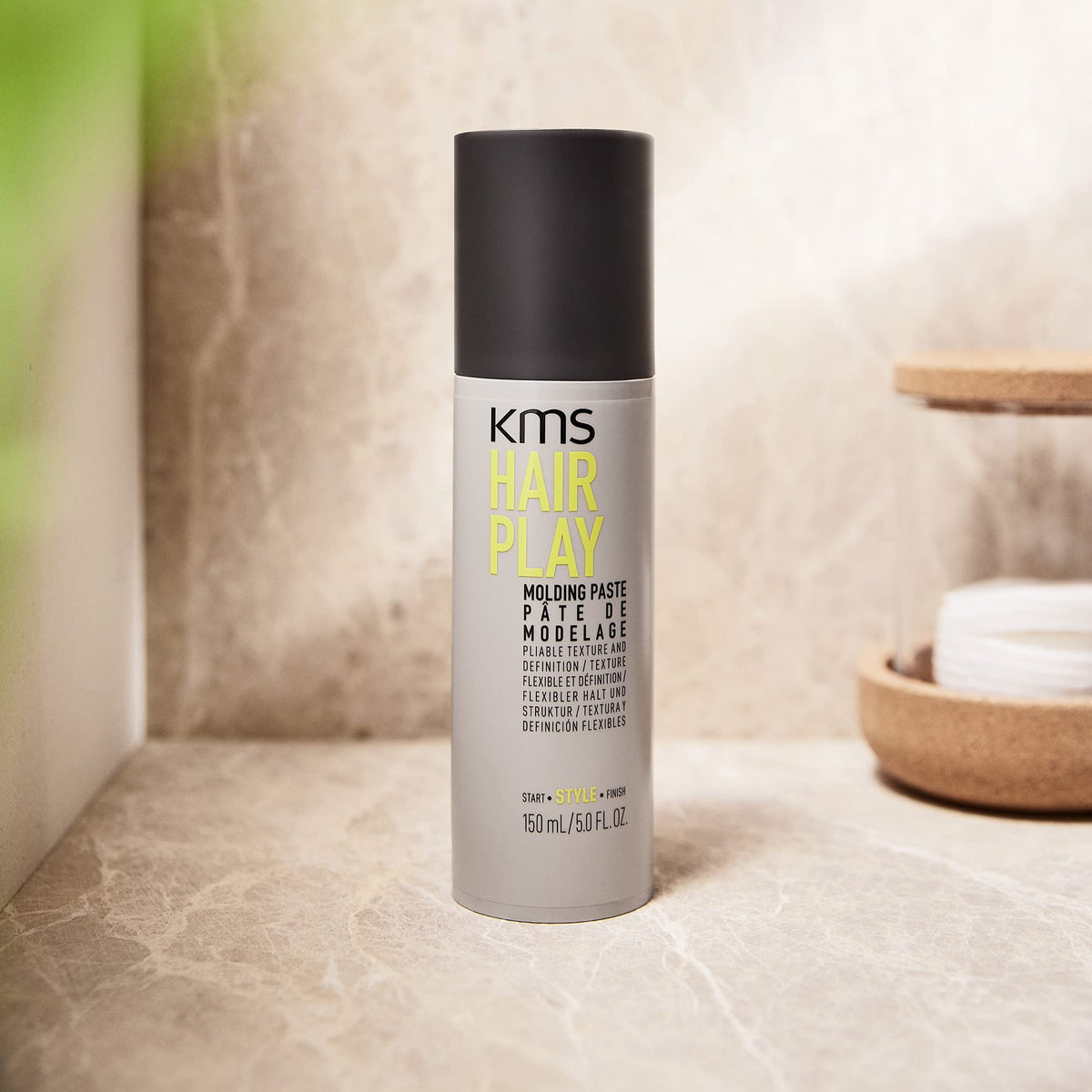 KMS product beside ruler illustrating 5 ounce size and travel convenience