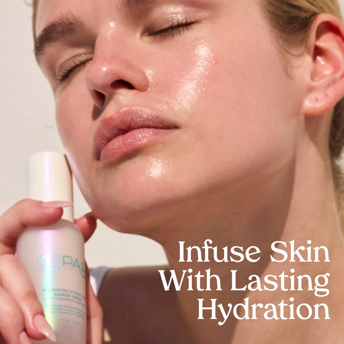 Kopari bottle beside moisturizer, displays layering with other skincare products