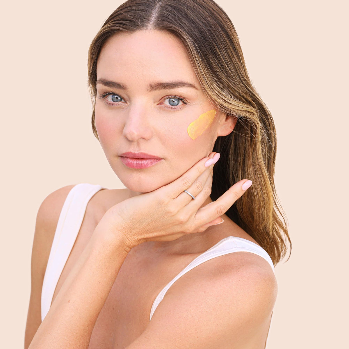 KORA Organics pearl-sized amount on fingers for correct application
