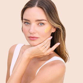 KORA Organics pearl-sized amount on fingers for correct application