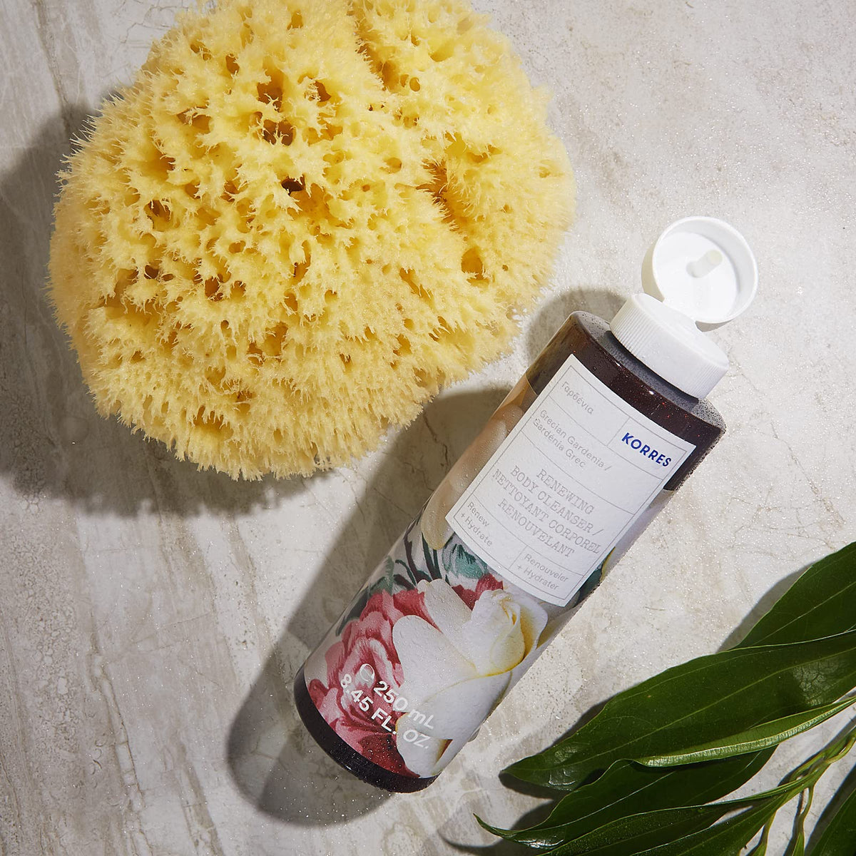 KORRES bottle in shower setting illustrating fragrant spa-like benefit
