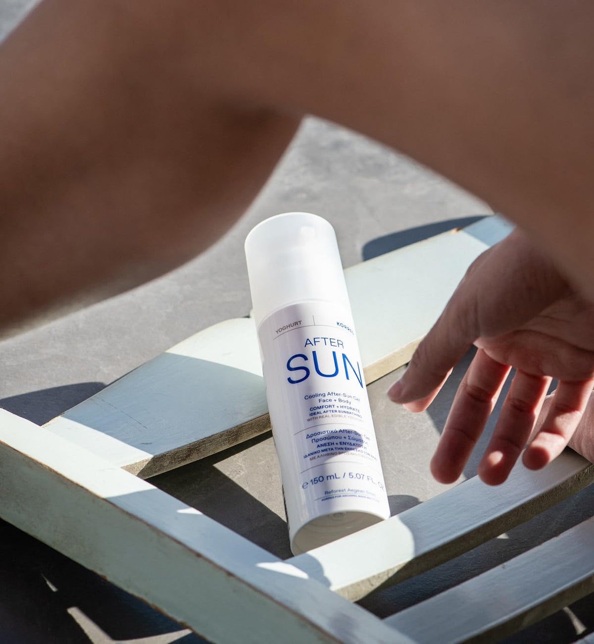 KORRES application on shoulder demonstrating soothing hydration after sun exposure