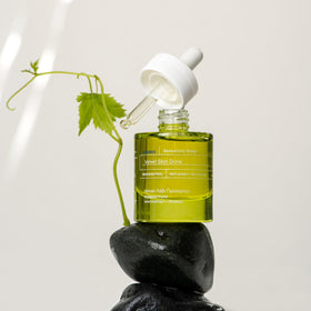 KORRES serum applied under makeup on cheek, displays non-greasy finish for daytime use