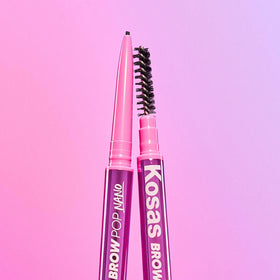 Kosas pencil held in hand to show slim scale and control