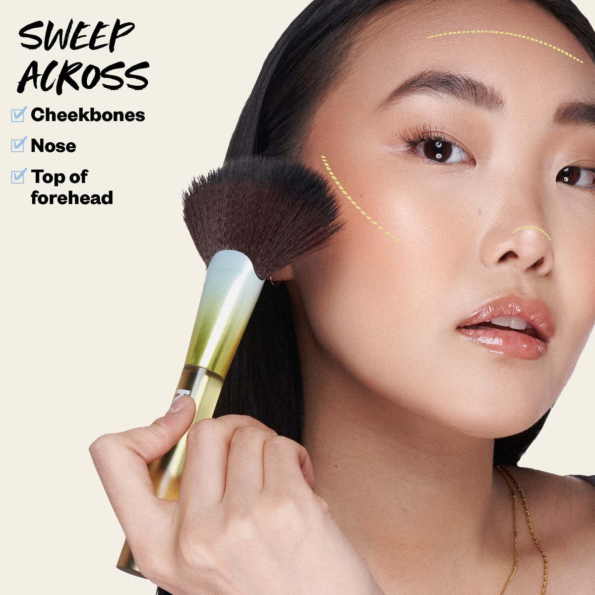 Kosas brush picking up powder with swatch showing buildable color payoff