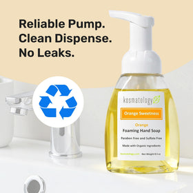 kosmatology bottle staged with fresh orange and leaves suggesting natural citrus aroma