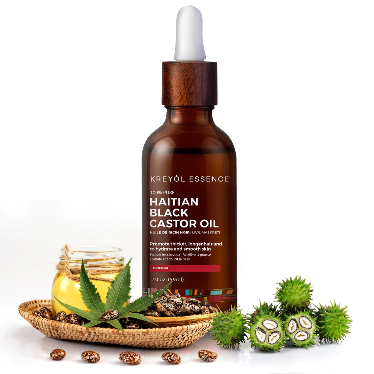 KREYÒL ESSENCE oil pouring from bottle showing rich texture and nourishment