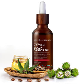 KREYÒL ESSENCE oil pouring from bottle showing rich texture and nourishment
