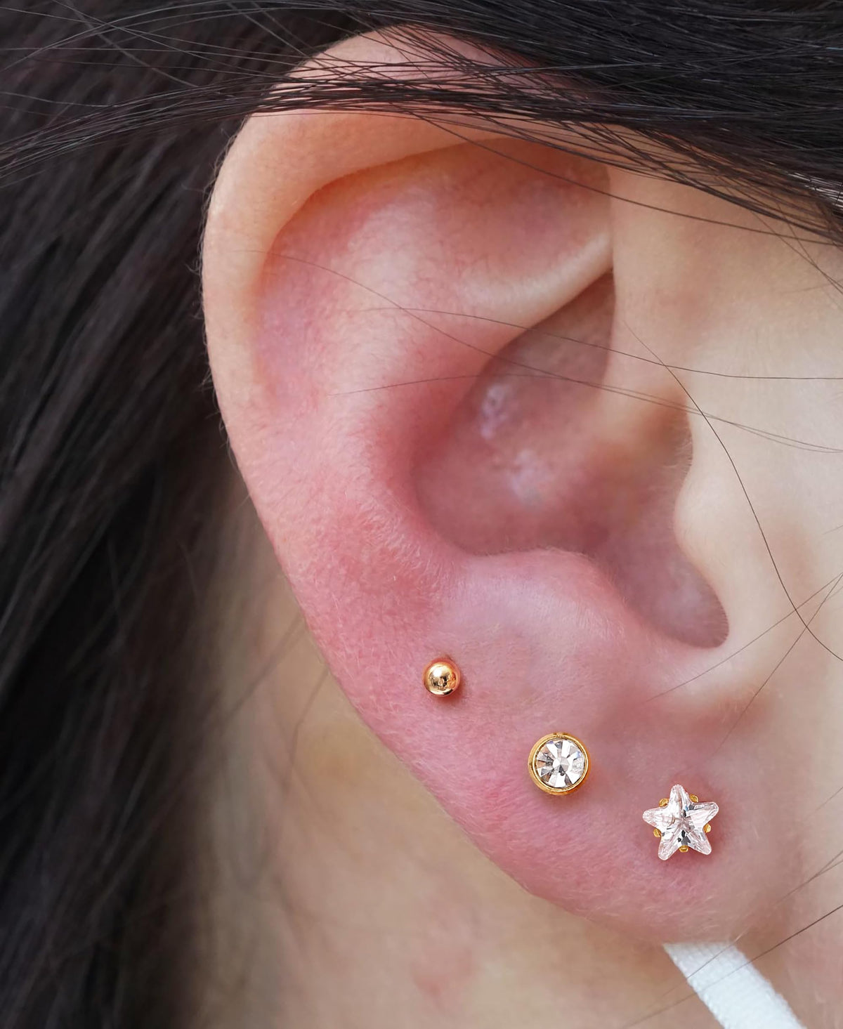KRFY lifestyle image of pierced ear wearing included stud, showcasing finished look