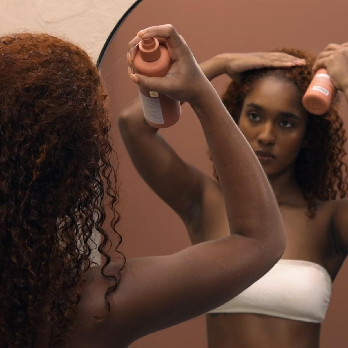 Kristin Ess application on curly hair demonstrating detangling and definition