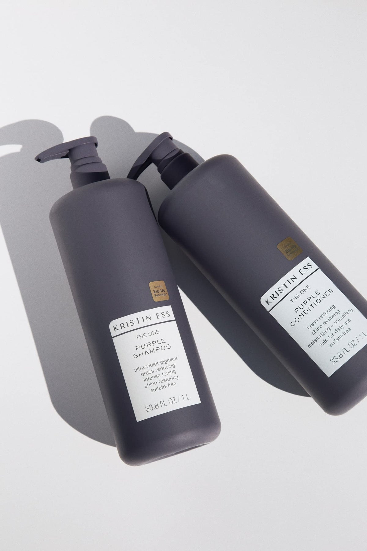 Close-up color-safe tag on Kristin Ess bottle indicating protection for dyed hair