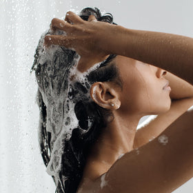 Kristin Ess conditioner creaminess on fingers delivering weightless hydration