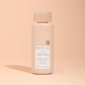 Kristin Ess conditioner being applied to hair illustrating detangling and softness