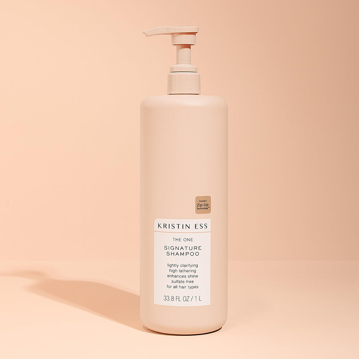 Kristin Ess shampoo in use on wet hair demonstrating hydration