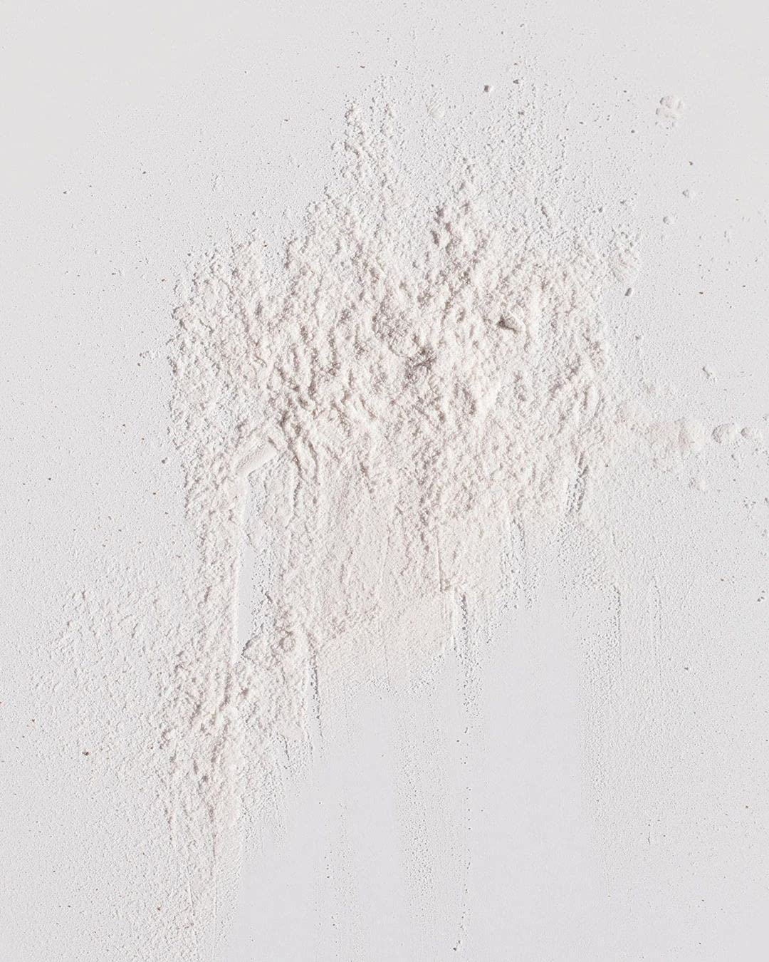 Kristin Ess open top revealing fine powder texture and easy non-aerosol dispensing benefit