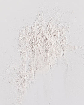 Kristin Ess open top revealing fine powder texture and easy non-aerosol dispensing benefit