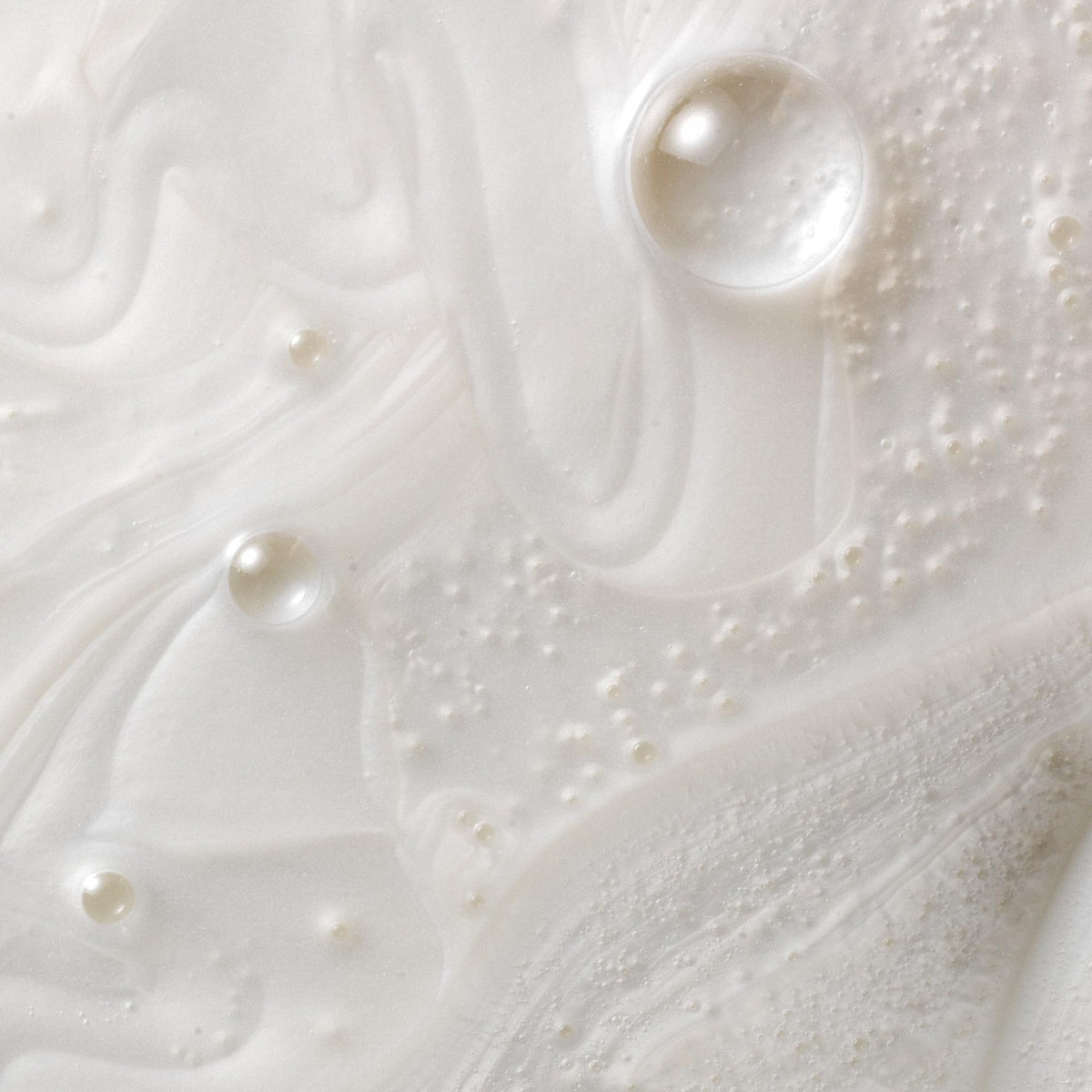 Kristin Ess cream texture illustrating moisturizing, non-greasy lather