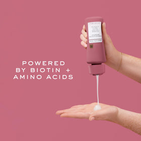 Kristin Ess shampoo label close-up highlighting biotin and sulfate-free benefits