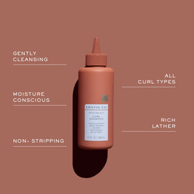 Kristin Ess shampoo creating rich lather for gentle, non‑stripping cleanse