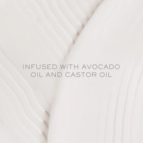 Kristin Ess conditioner spread on hand showing creamy texture for weightless softness benefit