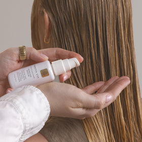 Kristin Ess working serum dispensed on hand to show lightweight, non-greasy texture