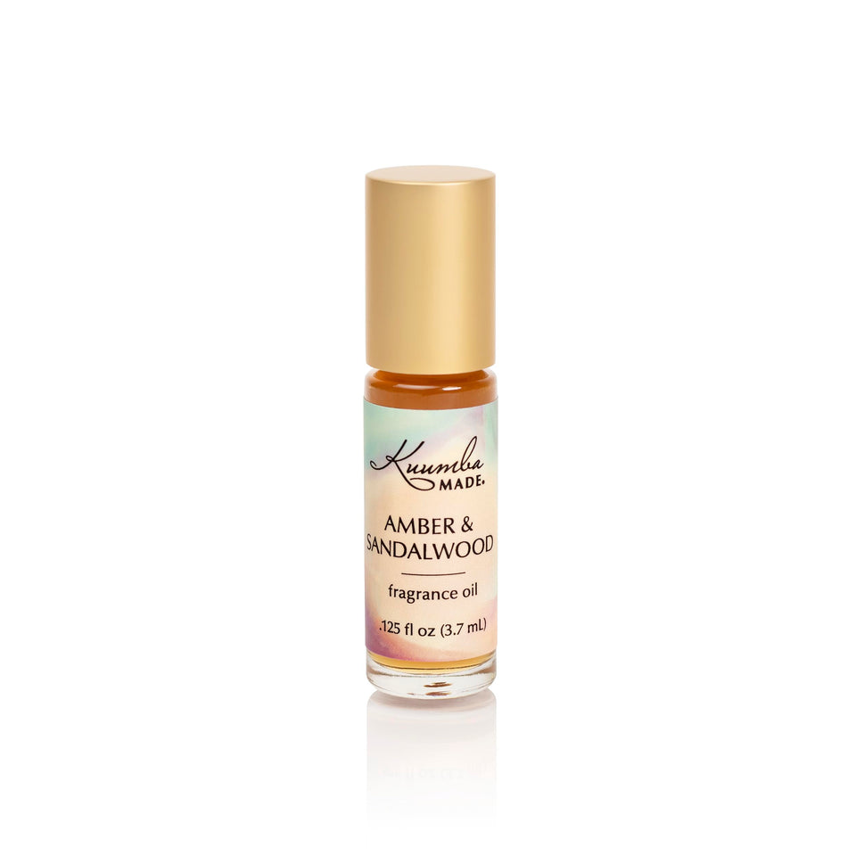 Kuumba Made front packaging showing compact amber and sandalwood roller for portability