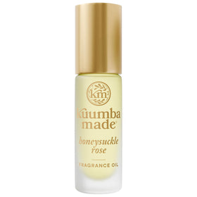 Kuumba Made bottle front view showing compact roll-on and floral design for easy carry