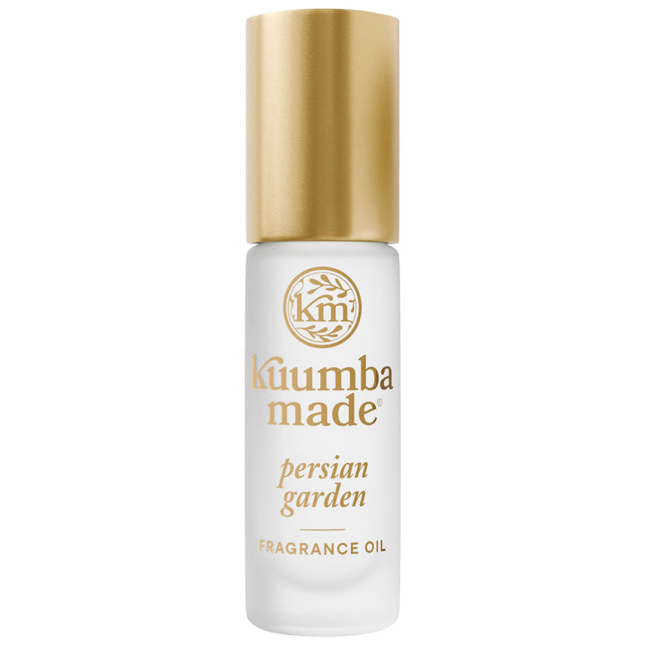 Kuumba Made bottle front view showing elegant perfume roller and palm-friendly size