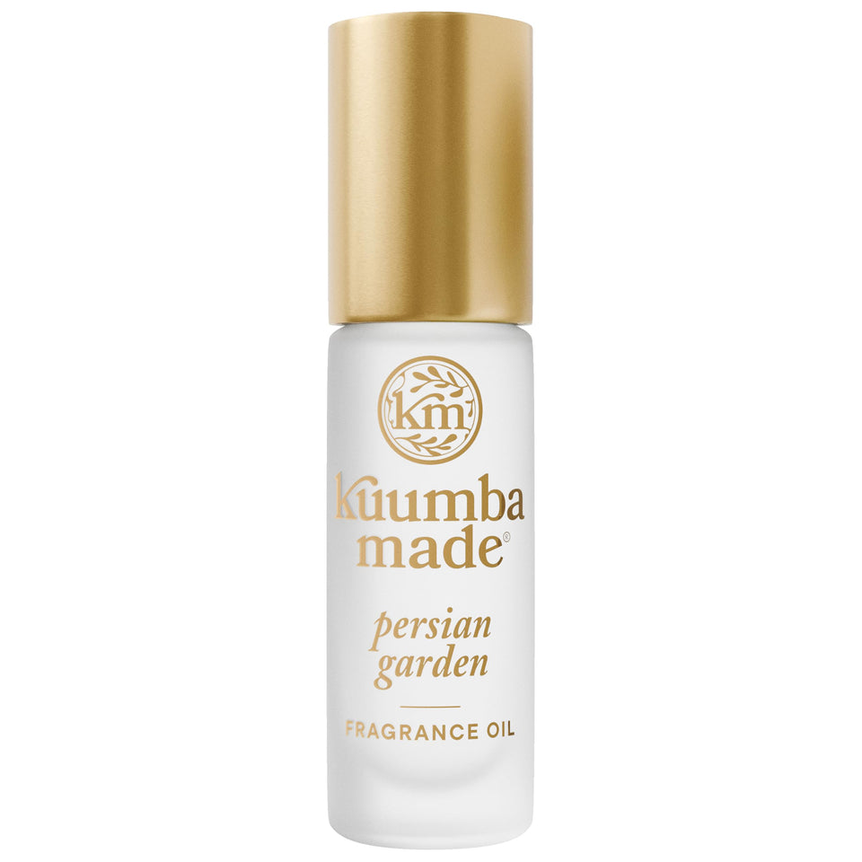 Kuumba Made bottle front view showing elegant perfume roller and palm-friendly size
