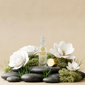 Kuumba Made bottle inside a handbag illustrating convenience for touch-ups