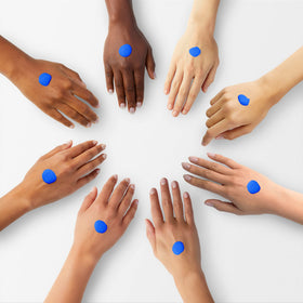 L.A. Girl blue mixing pigment size comparison next to hand showing bottle scale for professional use