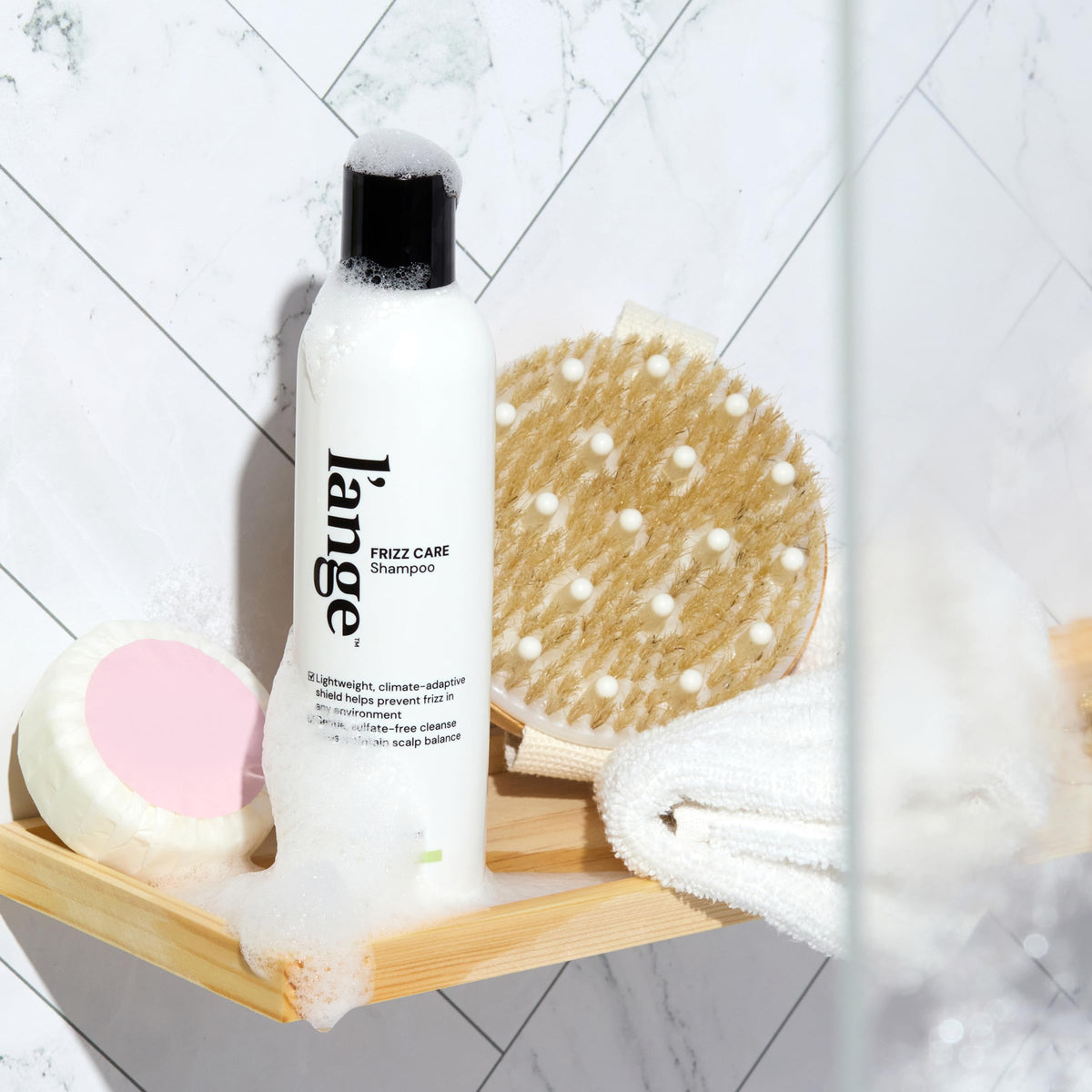 l'ange hair creamy shampoo texture on palm showing smooth application and slip