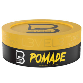 Bathroom shelf with L3 pomade among grooming items presenting everyday lifestyle use