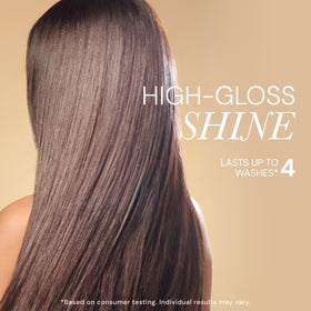 L'ANGE HAIR bottle beside hand showing true size for travel convenience