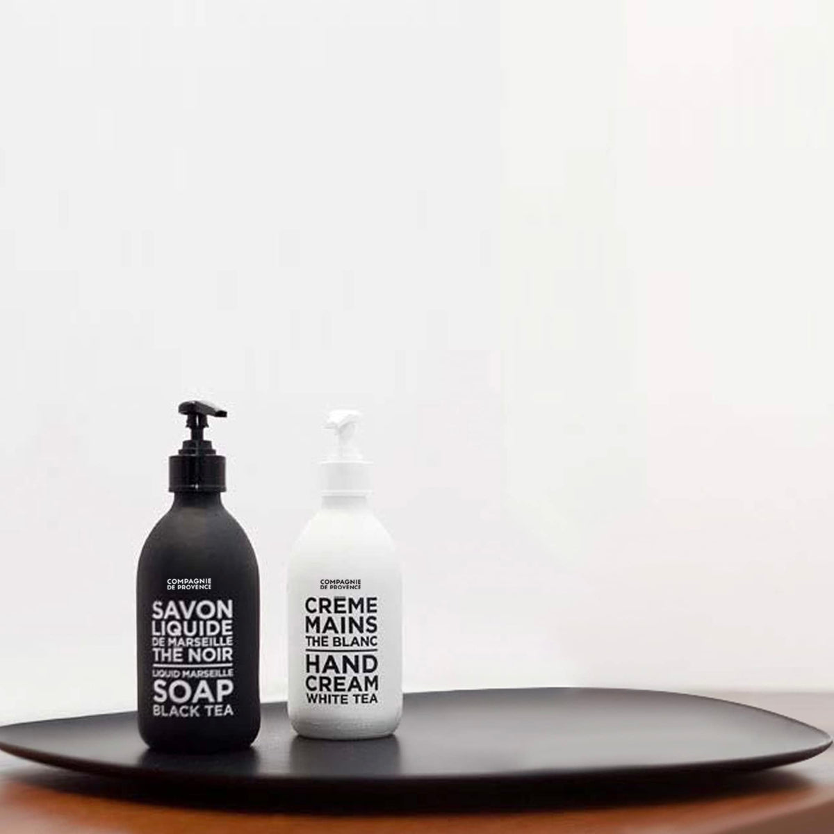 La Compagnie de Provence pouring refill pouch into glass bottle emphasizing waste reduction benefit