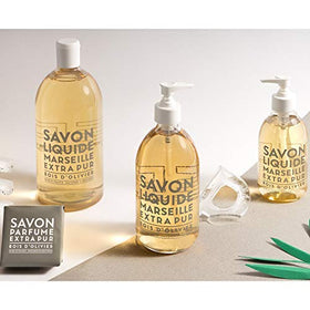 La Compagnie de Provence bottle held in hand to show 16.7 fl oz scale and refillable use