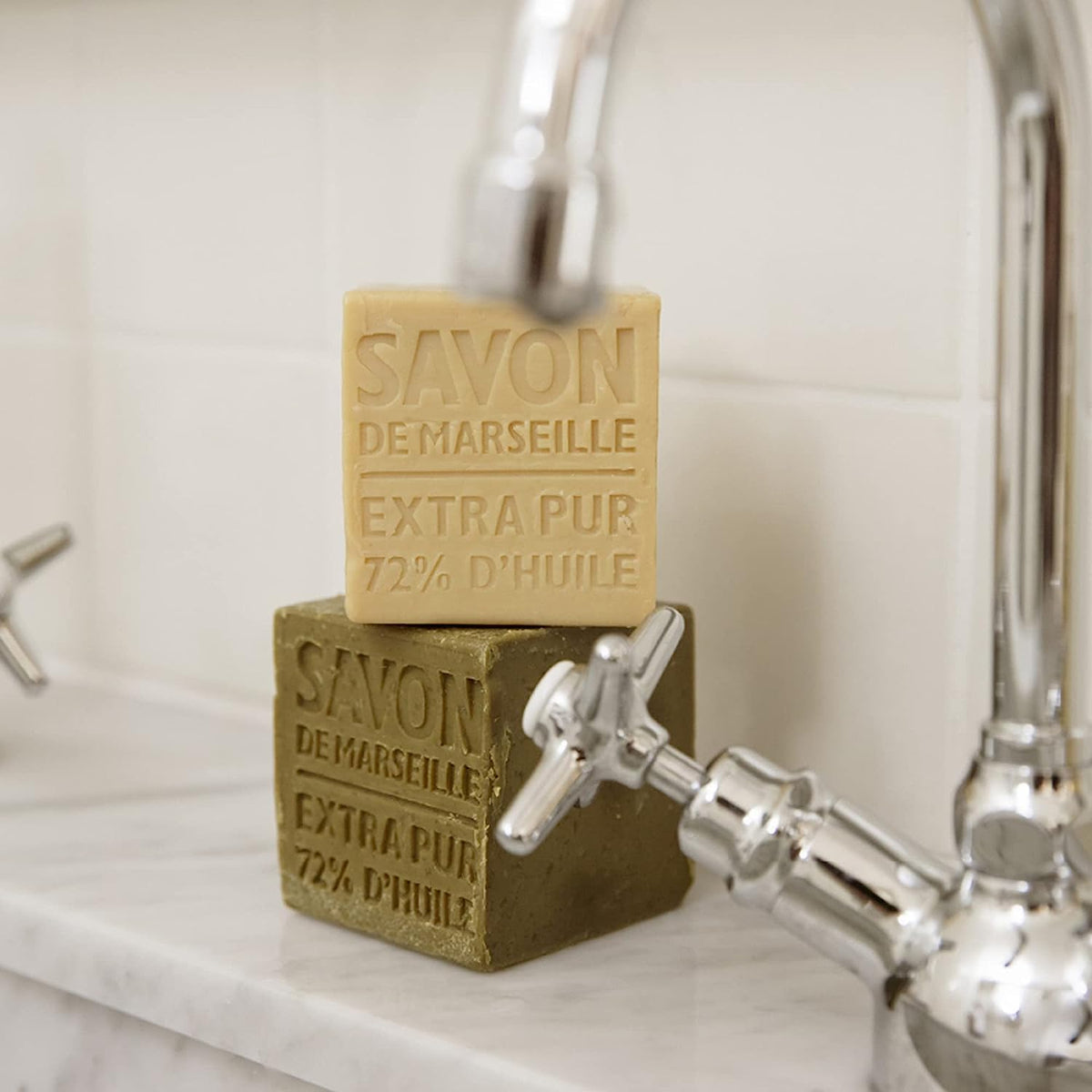 La Compagnie de Provence soap cube in hand illustrating substantial 400g size