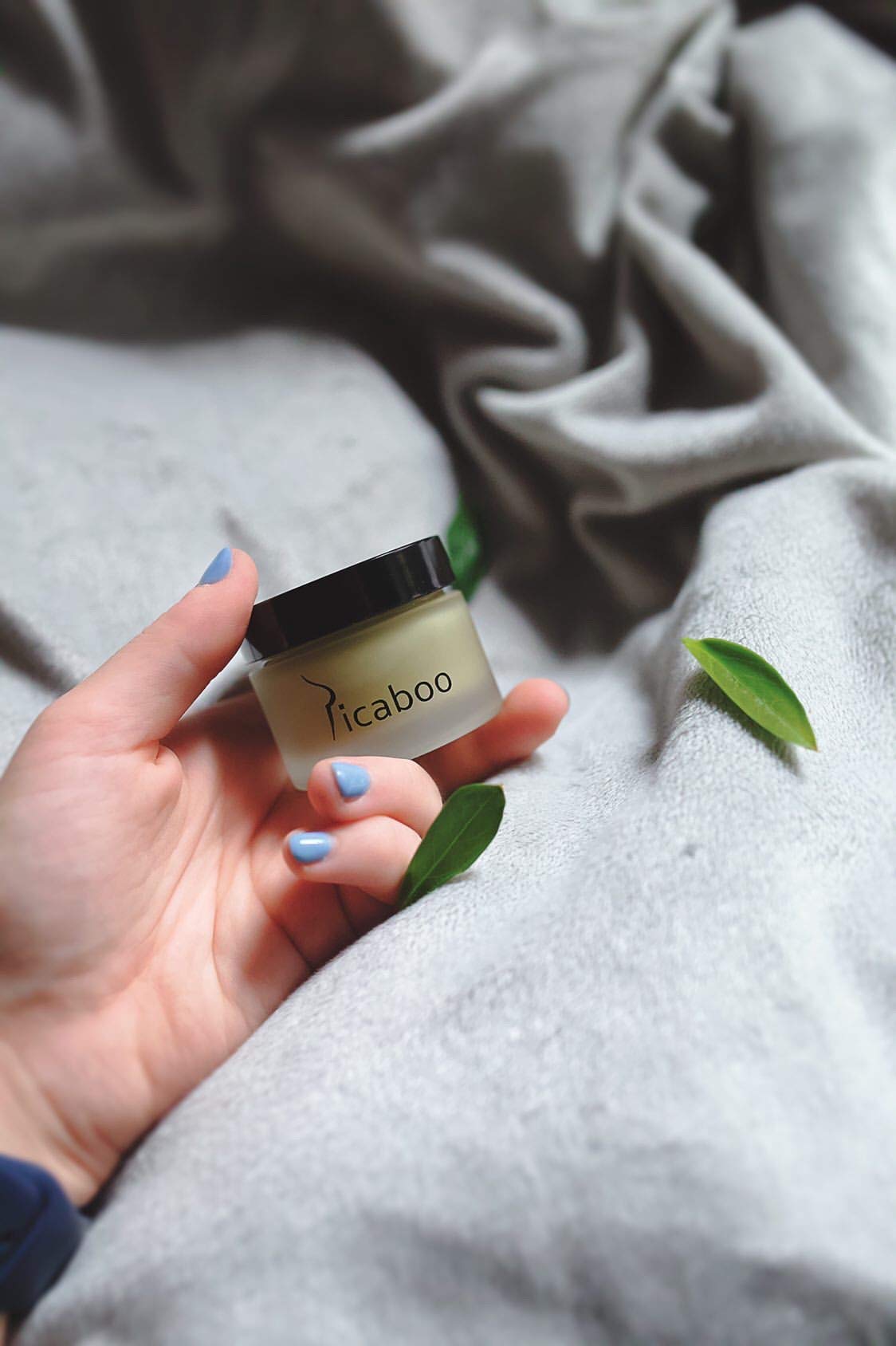 La Parea Wellness size comparison with coin highlighting portable 1 oz convenience