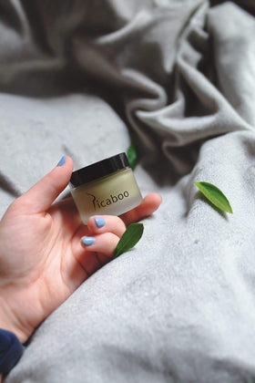 La Parea Wellness size comparison with coin highlighting portable 1 oz convenience