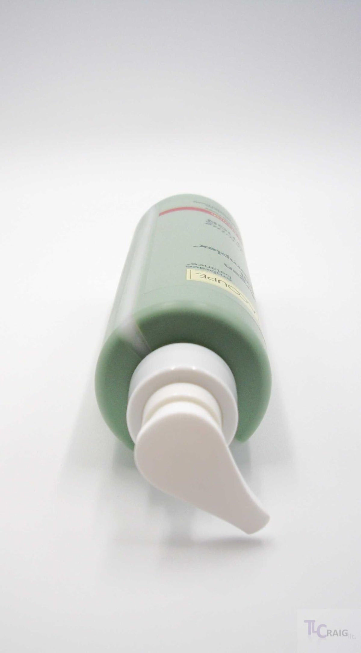 LACOUPE bottle beside a hand to show scale and convenient pump size