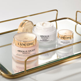 Lancôme on vanity next to mirror portraying morning routine and pampering benefit