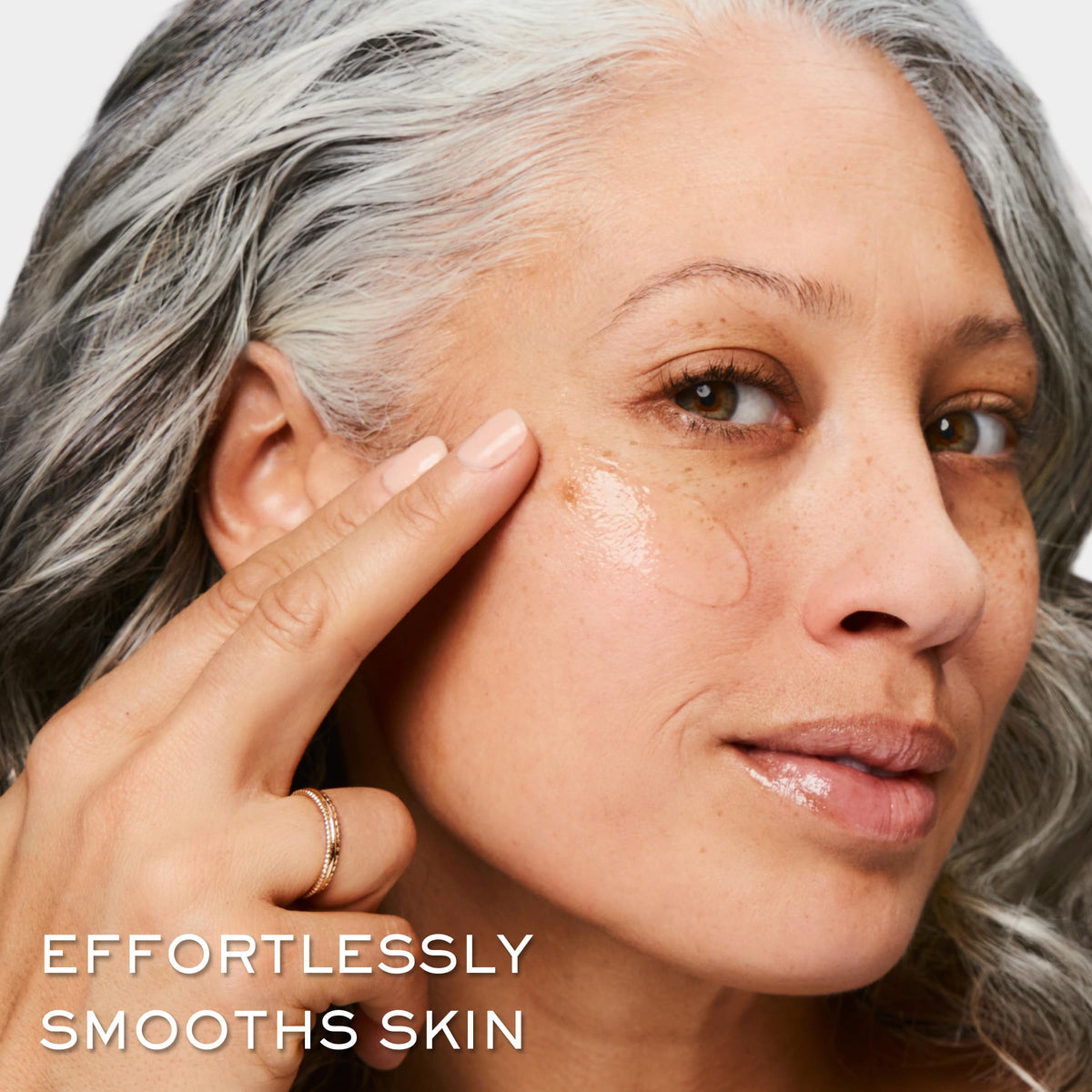 Lancôme lifestyle shot of person applying primer for longer makeup wear